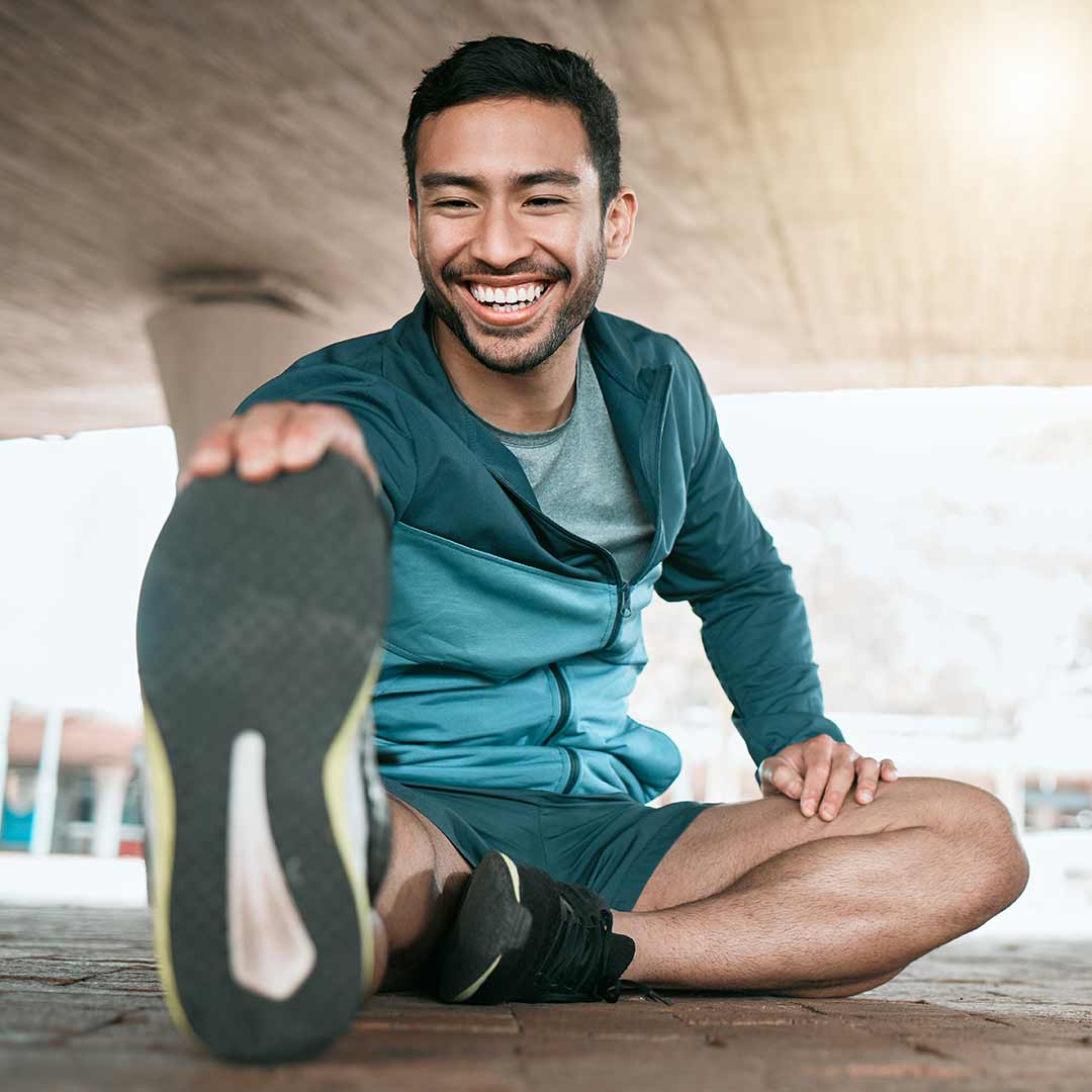 Man stretching and smiling