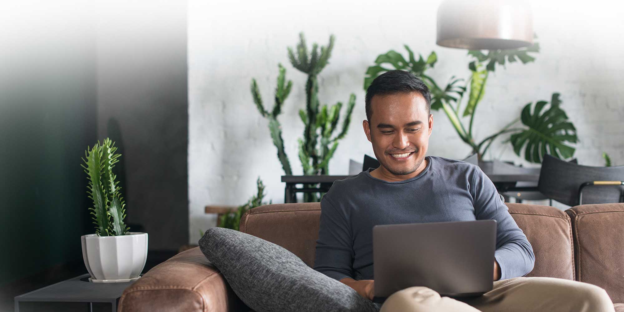 Man smiling at a laptop